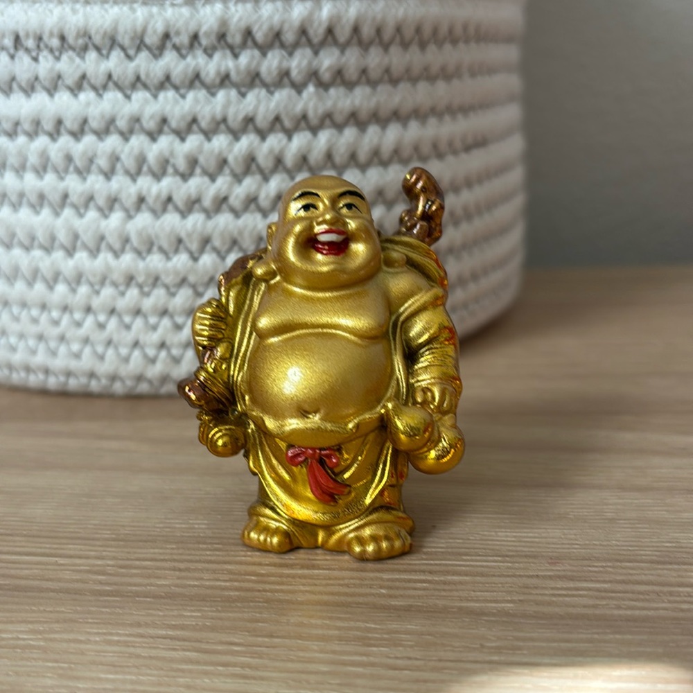 Gold Buddha with red bow